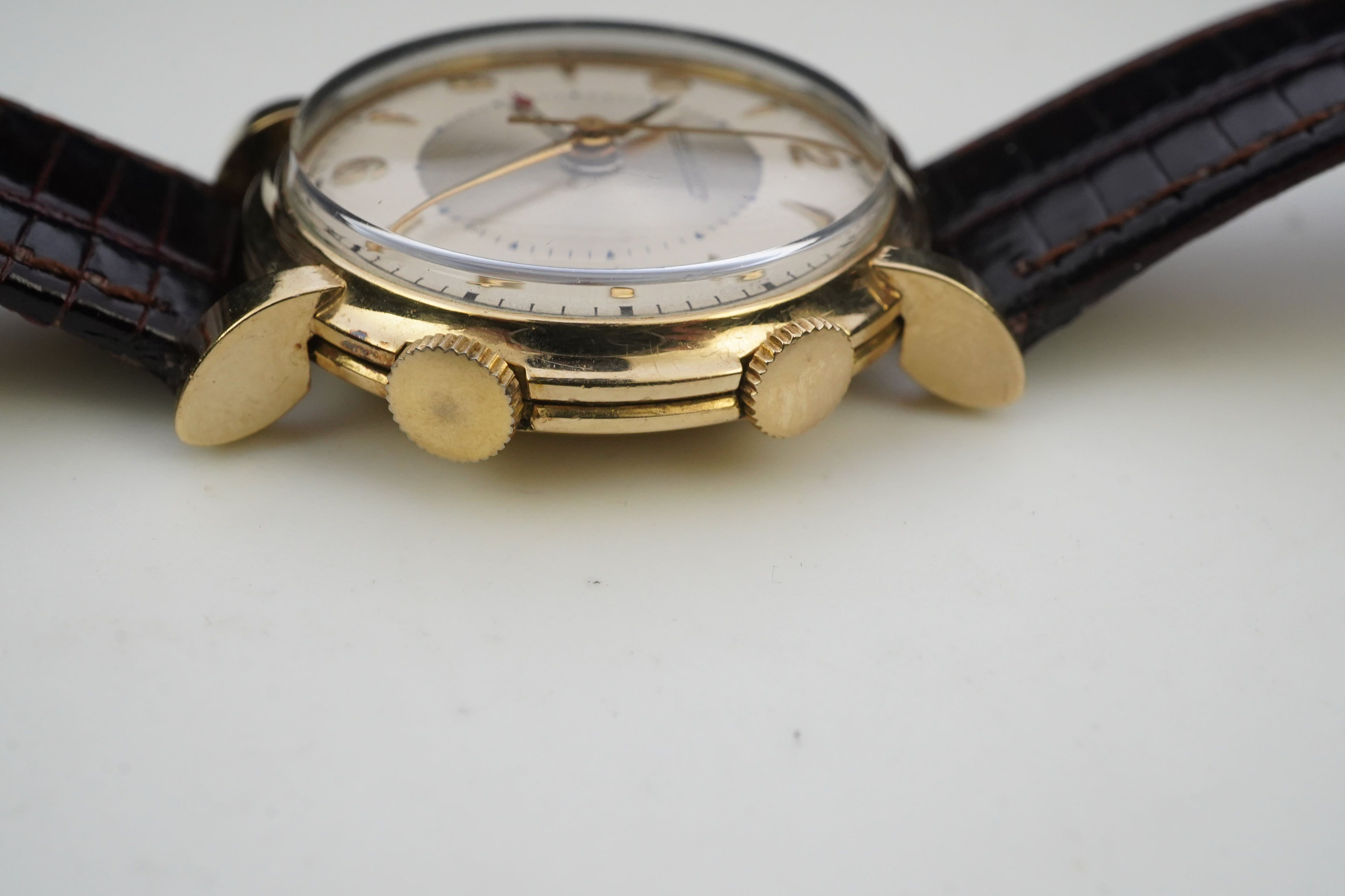 A gentleman's 1950's gold plated Jaeger LeCoultre Memovox manual wind wrist watch, on a later associated leather strap